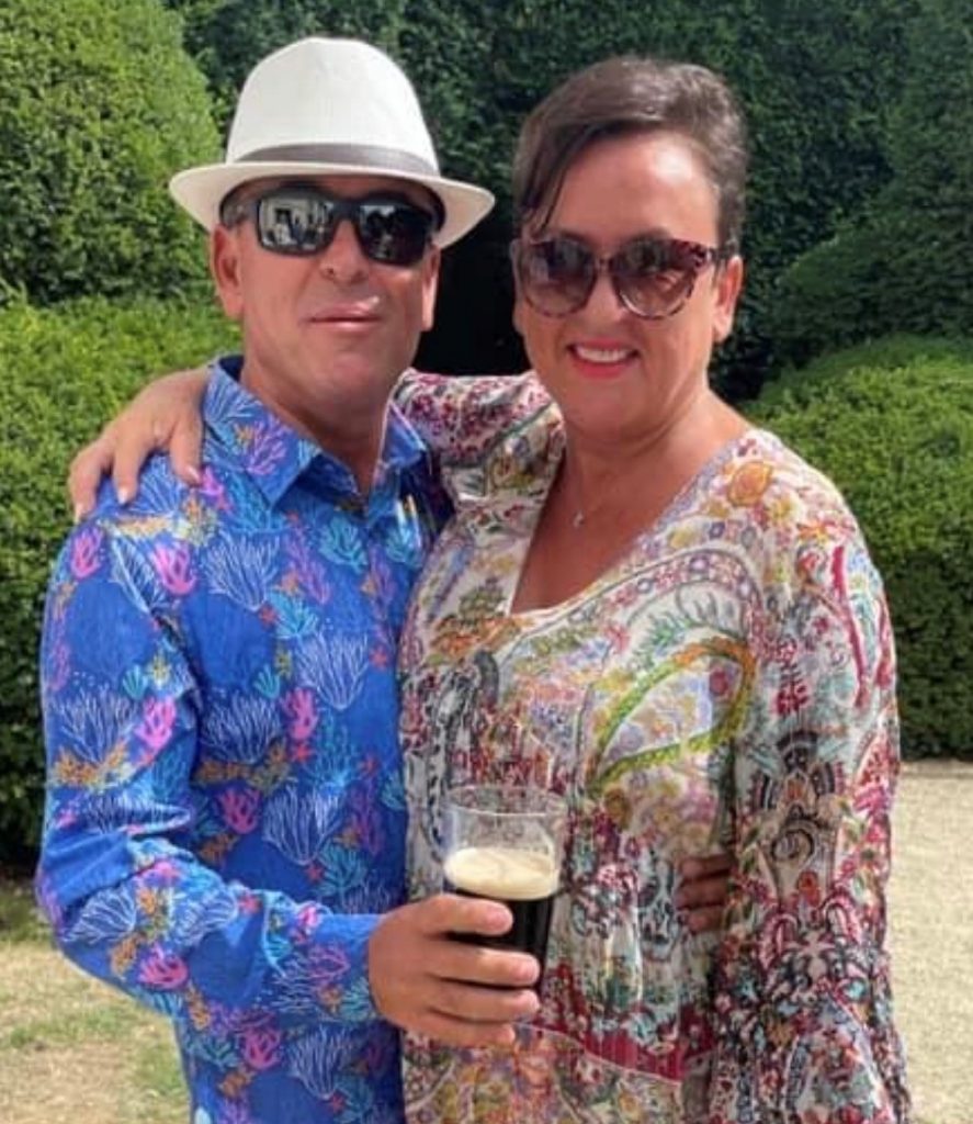 Jo receives her BEM from Lord Lieutenant for Warwickshire Tim Cox alongside Alex and her daughter Grace